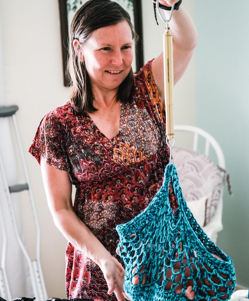 Tania weighing a newborn at a home visit.