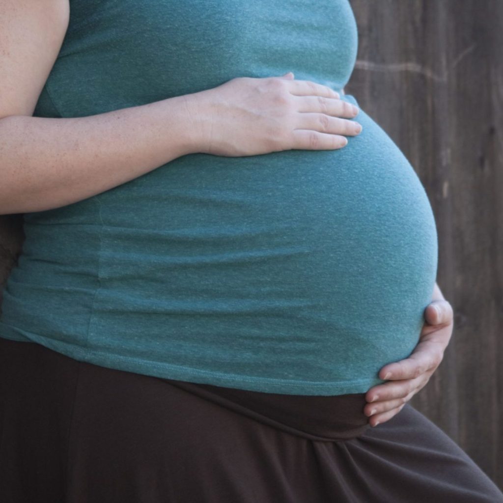 Photograph of mom holding her pregnancy belly.